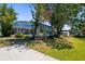Beautiful screened-in lanai overlooking the yard, with lush trees and a storage shed at 18093 Ohara Dr, Port Charlotte, FL 33948