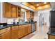 Well-lit kitchen featuring warm wood cabinets, granite countertops, and a view to the front yard at 18093 Ohara Dr, Port Charlotte, FL 33948