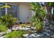 Lush garden with native foliage with decorative rock features adding an attractive touch to the property at 18093 Ohara Dr, Port Charlotte, FL 33948