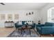 Bright living room with stylish blue seating, decorative art, and modern decor at 18093 Ohara Dr, Port Charlotte, FL 33948