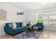 Bright living room with stylish blue seating, decorative art, and modern decor at 18093 Ohara Dr, Port Charlotte, FL 33948