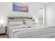 Bedroom with large bed, decorative pillows, side tables, and beachfront artwork at 18093 Ohara Dr, Port Charlotte, FL 33948