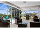 Spacious screened patio with outdoor seating and grill, perfect for entertaining at 18093 Ohara Dr, Port Charlotte, FL 33948