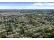 Wide aerial view of a residential area with trees and a glimpse of the ocean at 1825 Welland Dr, Clearwater, FL 33756