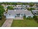 Aerial view of a single story home with a wide front lawn and a two car garage at 1825 Welland Dr, Clearwater, FL 33756