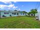View of the backyard including a fire pit, lounge chairs, and trampoline at 1825 Welland Dr, Clearwater, FL 33756