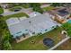 Aerial view of backyard featuring patio, fire pit, and trampoline at 1825 Welland Dr, Clearwater, FL 33756