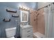 Well-lit bathroom featuring granite countertops, light fixtures, and soft pink tile shower at 1825 Welland Dr, Clearwater, FL 33756
