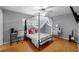 Neutral bedroom with a ceiling fan, natural light, and laminate wood flooring at 1825 Welland Dr, Clearwater, FL 33756