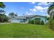 Charming light blue single story home with a well-manicured lawn and a spacious driveway at 1825 Welland Dr, Clearwater, FL 33756