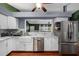 Well-appointed kitchen with stainless steel appliances, a farmhouse sink, and open layout at 1825 Welland Dr, Clearwater, FL 33756