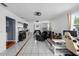 Spacious living room featuring tile floors, fan lighting, and lots of natural light at 1825 Welland Dr, Clearwater, FL 33756