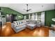 Bright living room with hardwood floors, a vaulted ceiling, and an abundance of natural light at 1825 Welland Dr, Clearwater, FL 33756