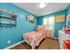 Bright blue bedroom with a twin bed and colorful decor at 1893 Harding St, Clearwater, FL 33765