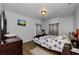 Inviting bedroom featuring hardwood floors and a comfortable bed with a floral comforter, creating a relaxing space at 1893 Harding St, Clearwater, FL 33765