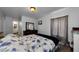 Serene bedroom features a floral bedspread, hardwood floors, and soft natural light, creating a cozy retreat at 1893 Harding St, Clearwater, FL 33765