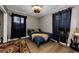 Bedroom with a bed, dark curtains, wood-look floors, and vintage decor at 1893 Harding St, Clearwater, FL 33765