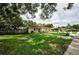 Inviting single-story home featuring a lush green lawn, pathway, and tidy landscaping, creating a welcoming exterior at 1893 Harding St, Clearwater, FL 33765