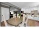Eat-in kitchen with white cabinets, stainless appliances, and a table with chairs, great for casual dining at 1893 Harding St, Clearwater, FL 33765
