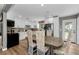 Eat-in kitchen featuring white cabinets, stainless steel appliances, and a dining area with floral upholstered chairs at 1893 Harding St, Clearwater, FL 33765