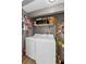 Laundry room with white washer, dryer, and shelving for storage at 1893 Harding St, Clearwater, FL 33765