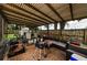 Covered patio area with comfortable seating and an outdoor grill at 1893 Harding St, Clearwater, FL 33765