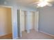 Bedroom with light blue walls, carpet flooring, ceiling fan, and closet with double doors at 201 Faithway Dr, Seffner, FL 33584
