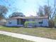 Charming home with a screened-in porch and a cozy yard, perfect for relaxing or entertaining guests at 201 Faithway Dr, Seffner, FL 33584