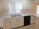 The kitchen features ample cabinet space and black appliances, perfect for preparing delicious meals at 201 Faithway Dr, Seffner, FL 33584