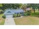 An overhead view of a single-story home with a lush lawn and landscaped front yard at 23067 Brighton Pl, Land O Lakes, FL 34639