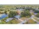An aerial view of a neighborhood featuring lush trees, a pond, and well-maintained homes at 23067 Brighton Pl, Land O Lakes, FL 34639