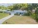 Charming single-story home with well-maintained lawn and mature landscaping, as seen from above at 23067 Brighton Pl, Land O Lakes, FL 34639