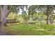 An inviting backyard featuring a tranquil pond, lush trees and comfortable seating, perfect for enjoying the outdoors at 23067 Brighton Pl, Land O Lakes, FL 34639