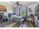 Comfortable bedroom with modern ceiling fan, a car poster, and a window showcasing natural light at 23067 Brighton Pl, Land O Lakes, FL 34639