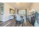 Bright dining room with modern decor, wood floors, and large windows at 23067 Brighton Pl, Land O Lakes, FL 34639
