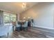 Bright dining room with modern decor, wood floors, and sliding glass doors to the patio at 23067 Brighton Pl, Land O Lakes, FL 34639