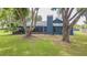 House exterior showcasing backyard, trees, screened in patio and chimney at 23067 Brighton Pl, Land O Lakes, FL 34639