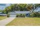 Charming single-story home with a well-maintained lawn, mature landscaping, and an attached two-car garage at 23067 Brighton Pl, Land O Lakes, FL 34639