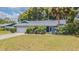 Charming single-story home with a well-maintained lawn, mature landscaping, and an attached two-car garage at 23067 Brighton Pl, Land O Lakes, FL 34639