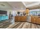 View of kitchen with wood cabinets, granite countertops, stainless appliances and wood flooring at 23067 Brighton Pl, Land O Lakes, FL 34639