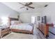 View of main bedroom with wood flooring, TV, mini fridge, and ensuite bathroom entrance at 23067 Brighton Pl, Land O Lakes, FL 34639