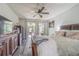 View of main bedroom with wood flooring, sliding doors to the patio and large windows at 23067 Brighton Pl, Land O Lakes, FL 34639