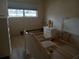 Bedroom showcasing white dressers, empty bed frames, neutral carpet, and a window at 2459 Franciscan Dr # 29, Clearwater, FL 33763
