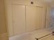 Bedroom with sliding closet doors and white carpet and minimal furnishings at 2459 Franciscan Dr # 29, Clearwater, FL 33763