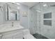 Bathroom featuring a modern shower with geometric tiles, a white vanity, and updated finishes at 2525 W Bay Dr # A46, Largo, FL 33770