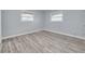 Bright bedroom features hardwood floors and two windows at 2525 W Bay Dr # A46, Largo, FL 33770
