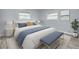Comfortable bedroom boasts serene decor, a bed with accent pillows, and soft natural light at 2525 W Bay Dr # A46, Largo, FL 33770