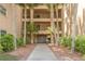 The front entrance of the condo shows covered access and mature landscaping at 2525 W Bay Dr # A46, Largo, FL 33770