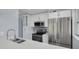 Modern kitchen featuring stainless steel appliances, white cabinets, and backsplash at 2525 W Bay Dr # A46, Largo, FL 33770