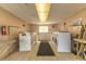 Community laundry room with multiple washers and dryers and folding tables at 2525 W Bay Dr # A46, Largo, FL 33770